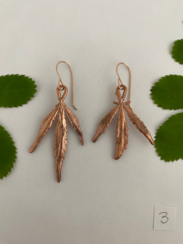 real cannabis leaf earrings electroplated with recycled copper ans 14 karat gold by simple wealth art made in usa