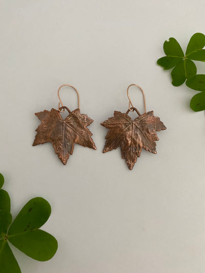 real mallow leaves encased in recycled copper 14 karat gold earwires by simple wealth art made in usa