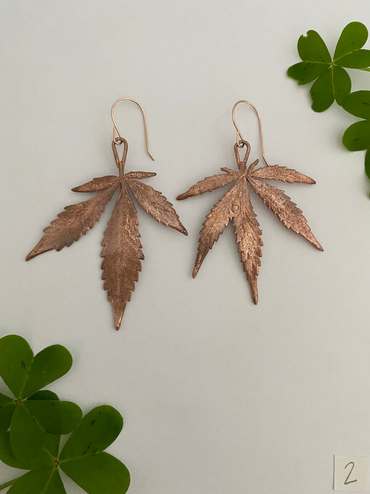 real cannabis leaf earrings electroplated with recycled copper ans 14 karat gold by simple wealth art made in usa