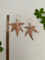 real cannabis leaf earrings electroplated with recycled copper ans 14 karat gold by simple wealth art made in usa