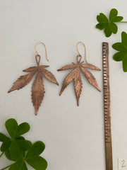 real cannabis leaf earrings electroplated with recycled copper ans 14 karat gold by simple wealth art made in usa