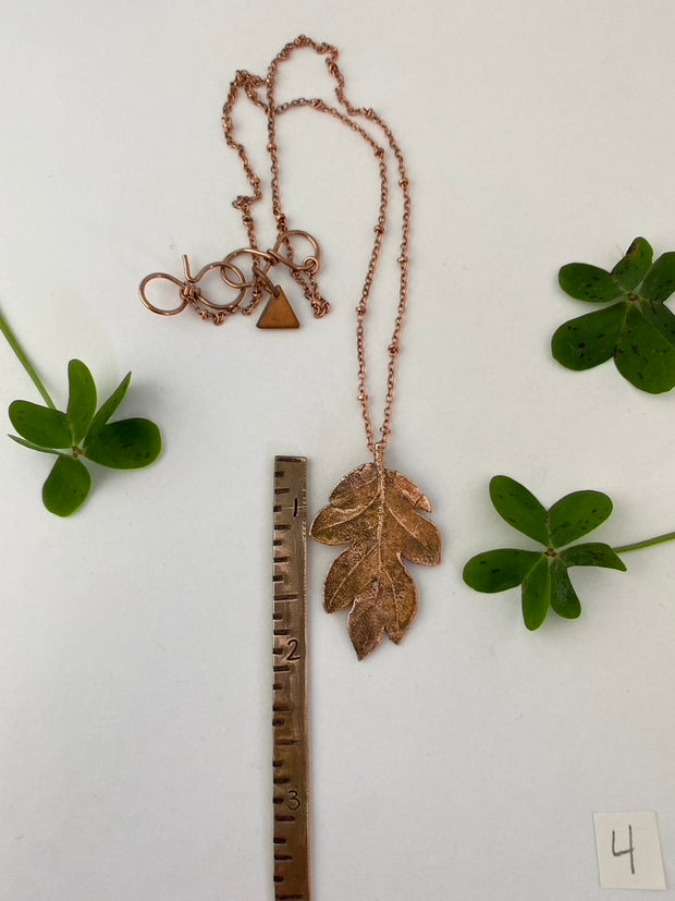 real oak leaf encased in recycled copper infinity clasp simple wealth art made in usa