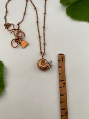 tiny snail shell electroplated in recycled copper with tiny quartz crystals made in usa simple wealth art