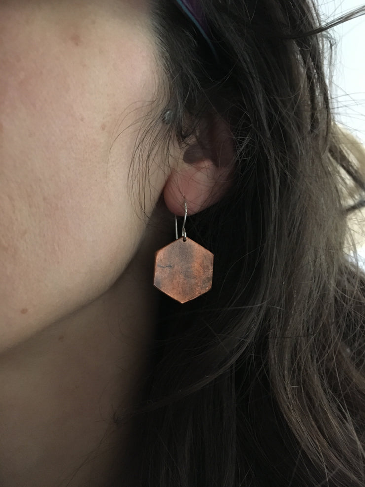 copper hexagon recycled pipe earrings worn by human upcycle simple wealth art